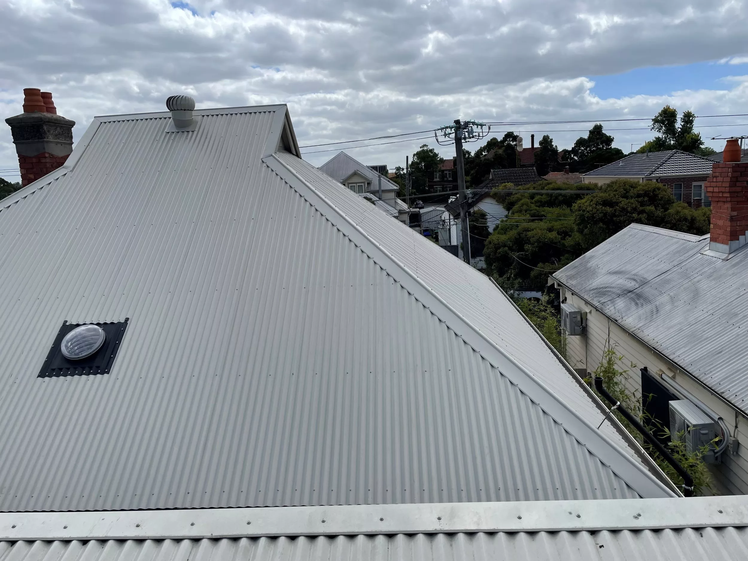 Close-up image of a gray corrugated roof after restoration