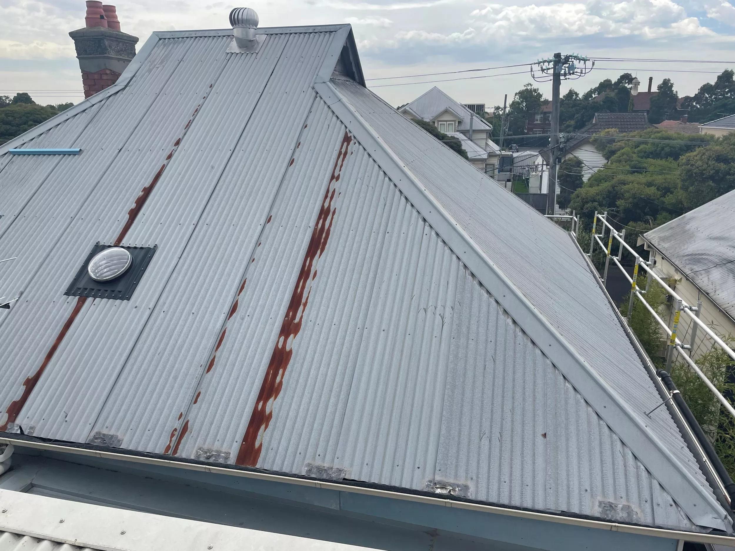 Close-up image of a gray corrugated roof before restoration