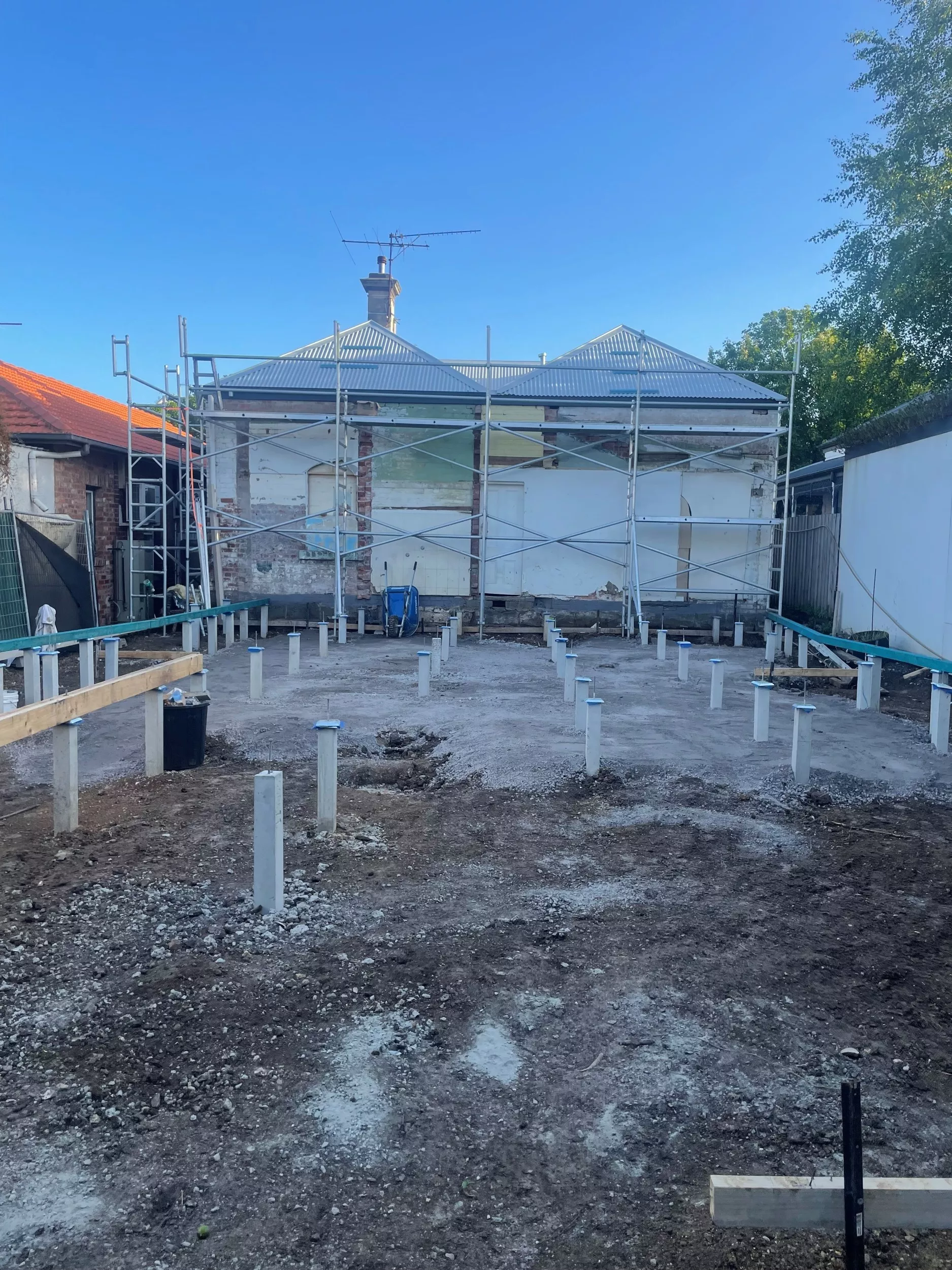 Back view of a house with scaffolding and a zincalume roof installed